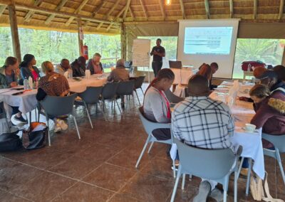 Sustainable landscaping workshop with diverse attendees in eco-friendly outdoor venue.