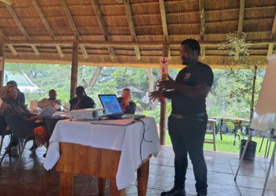 Meeting outdoors with eco-friendly presentation on sustainable landscaping and green solutions at a lush venue.